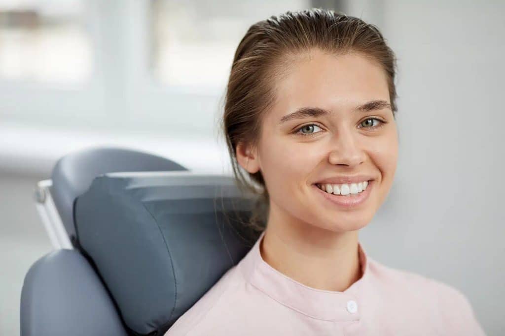 beautiful girl smiling after receiving dental treatment