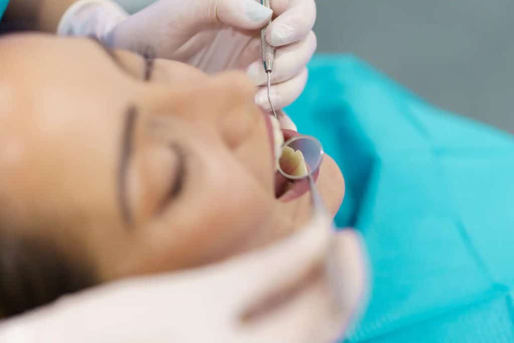 Dentist examining patients teeth