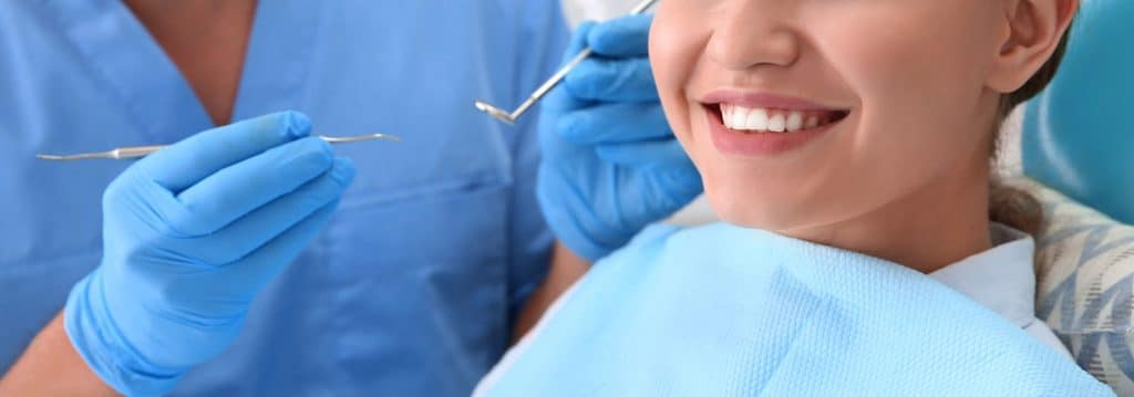 Girl smiling after receiving dental treatment